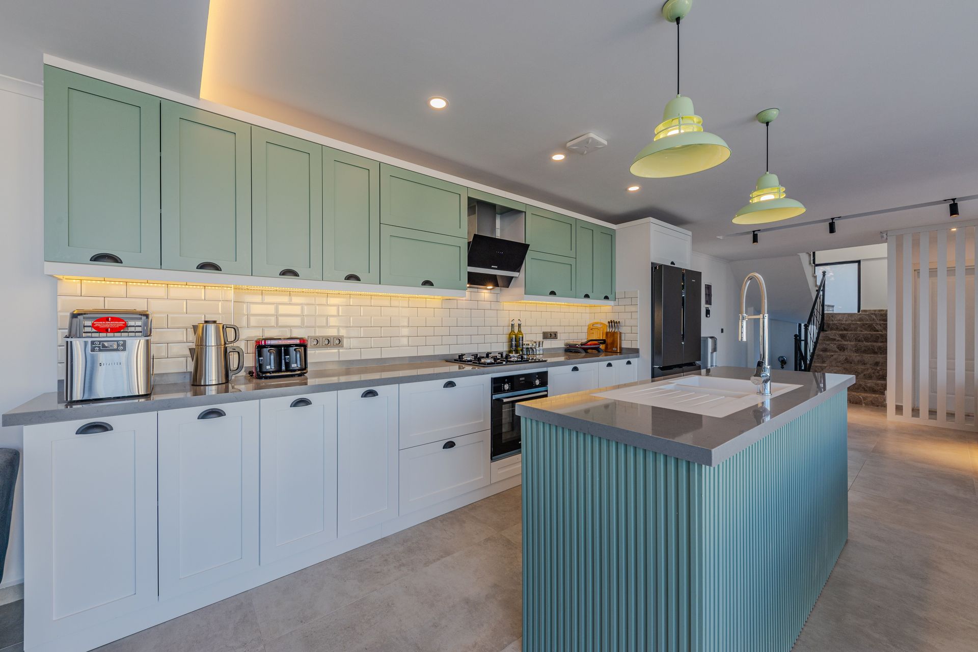 Stylish kitchen featuring contemporary design, an island, and modern appliances.